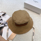 Soft canvas bucket hat with embossed leather logo patch and adjustable chin strap