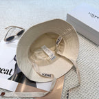 Soft canvas bucket hat with embossed leather logo patch and adjustable chin strap