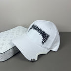 White cotton cap with black graphic embroidery and sculpted brim